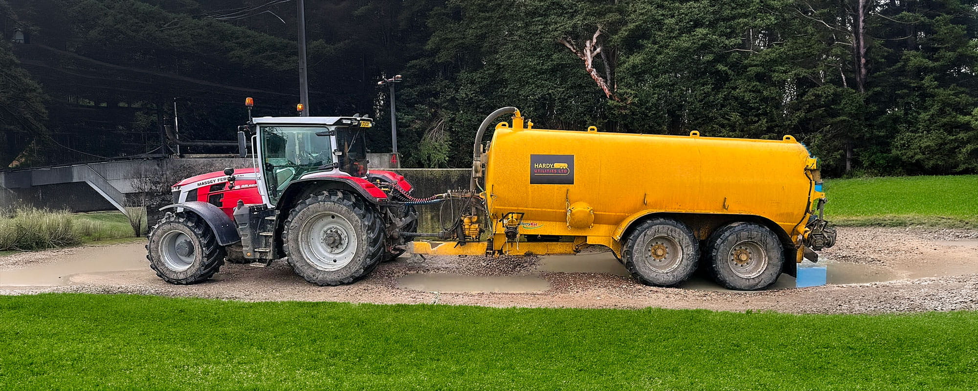 Hardy Utilities slurry tanker and Massey Ferguson tractor providing liquid waste transport and dewatering support at an industrial site.